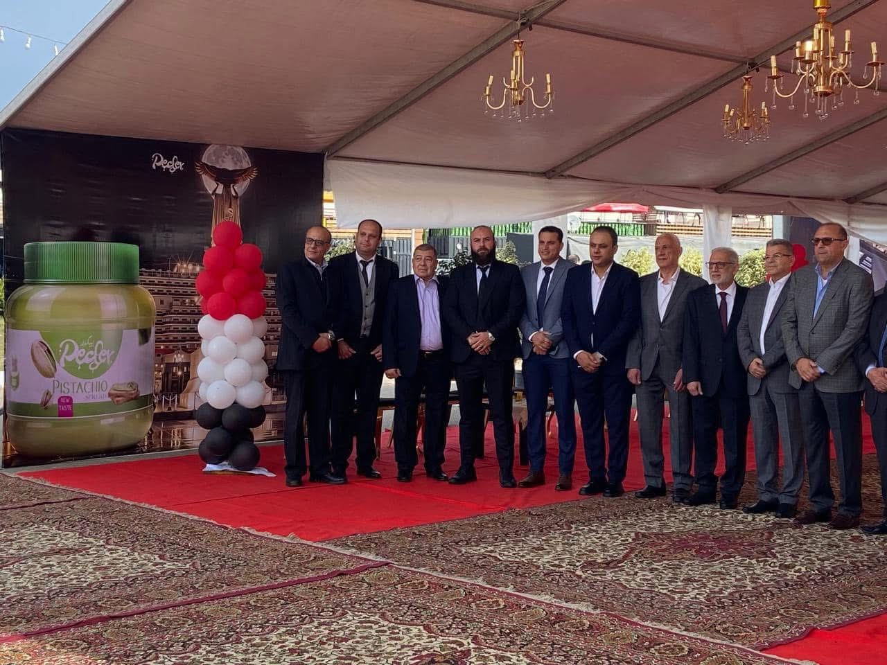 Ahmed Morsi in a suit with the Pecder team and company guests